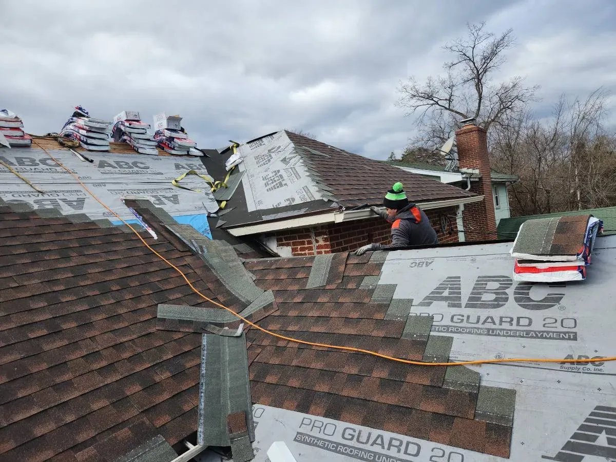 New shingle roof being installed over synthetic underlayment